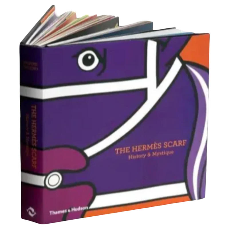 Book titled 'The Hermès Scarf: History & Mystique' with a purple cover featuring eye design.