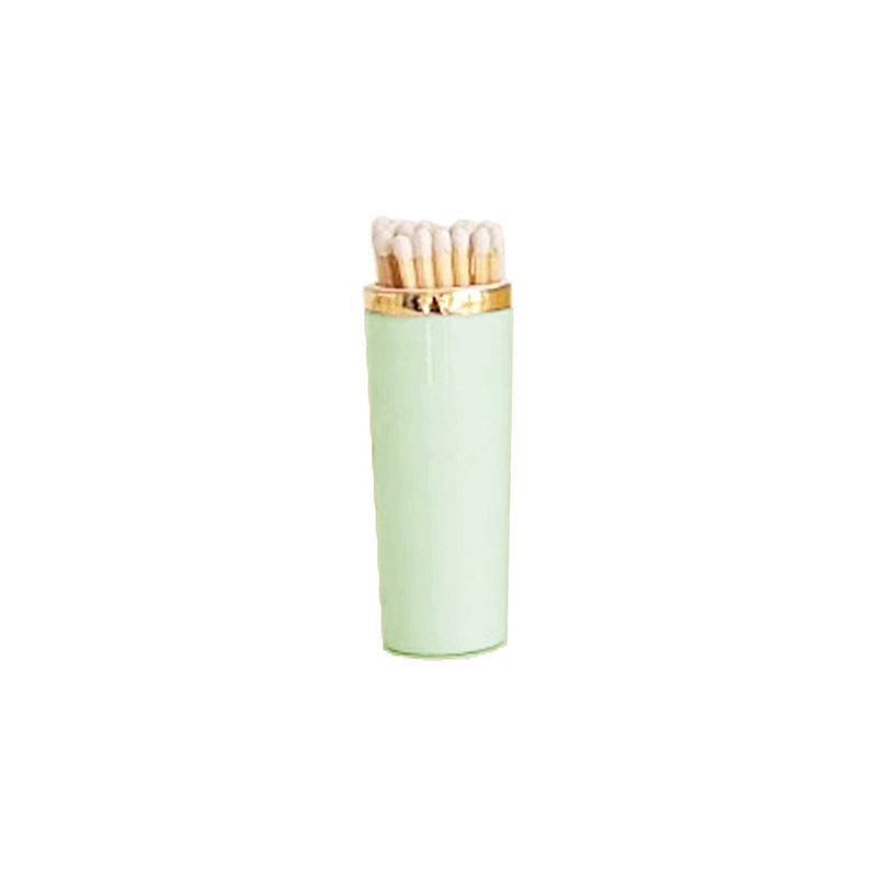 Light green matches with gold cap on a white background