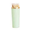 Mint green lip balm with gold cap on a white background
