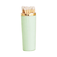 Mint green lip balm with gold cap on a white background