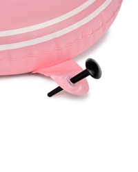 Close-up of a pink inflatable pool float with black nozzles on a white background