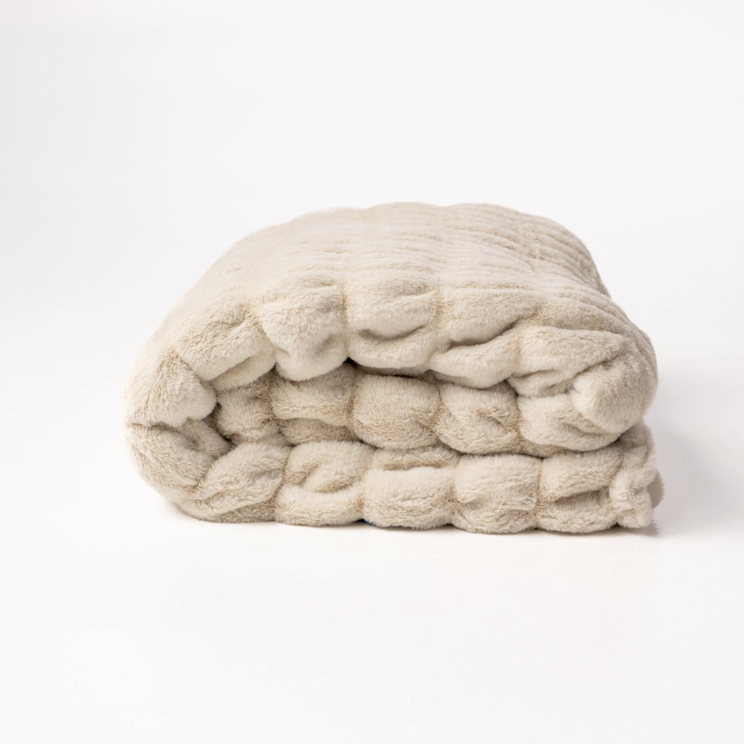 Stack of cream-colored yarn on a white background