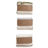 Three folded towels with brown labels on a white background