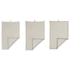 Three beige towels hanging on a white background