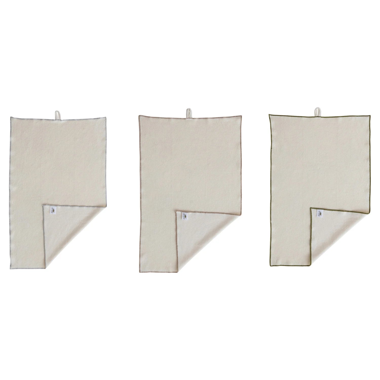 Three beige towels hanging on a white background