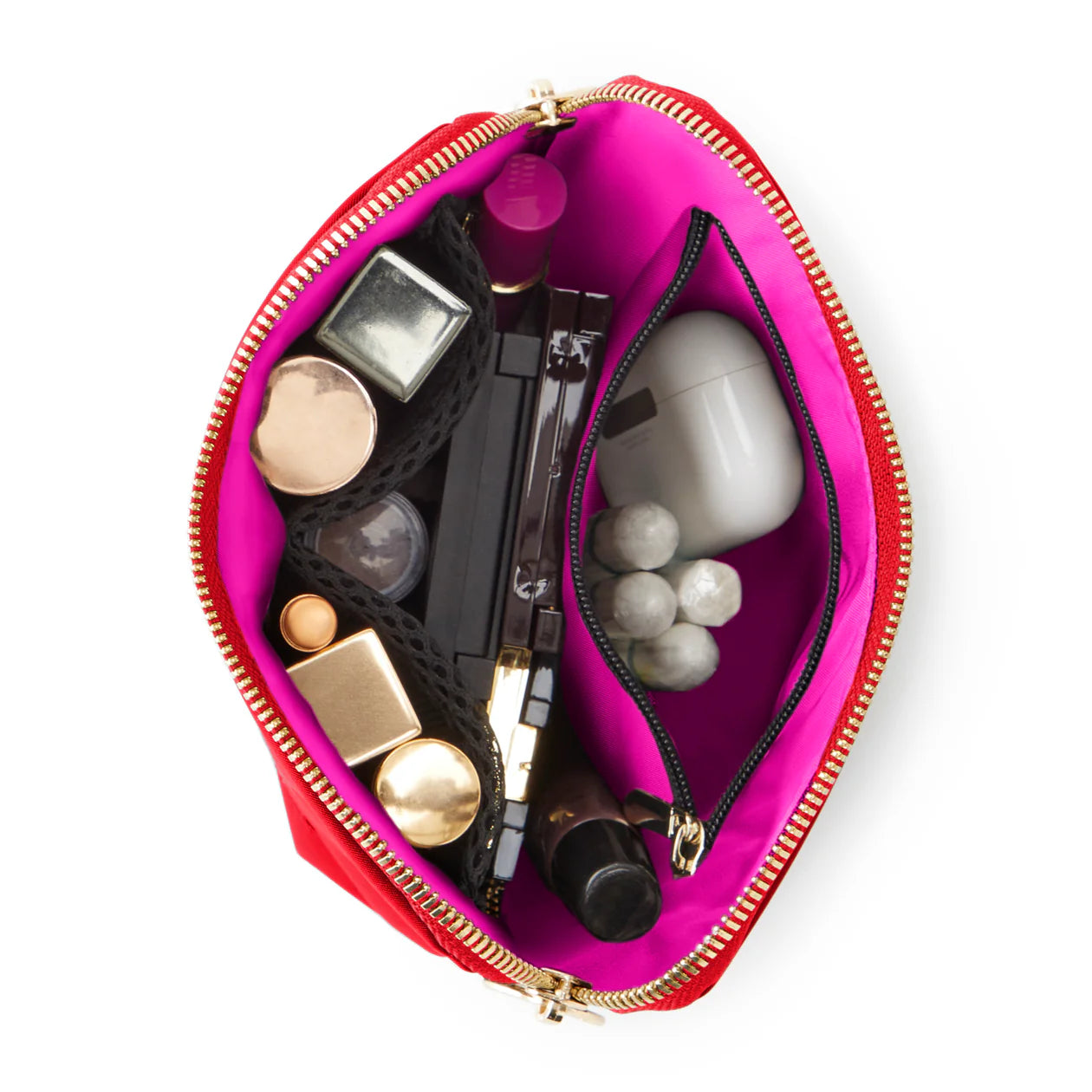 Pink makeup bag with various cosmetic items on a white background