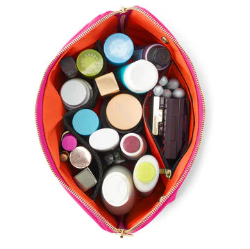Makeup items in a pink and orange pouch on a white background