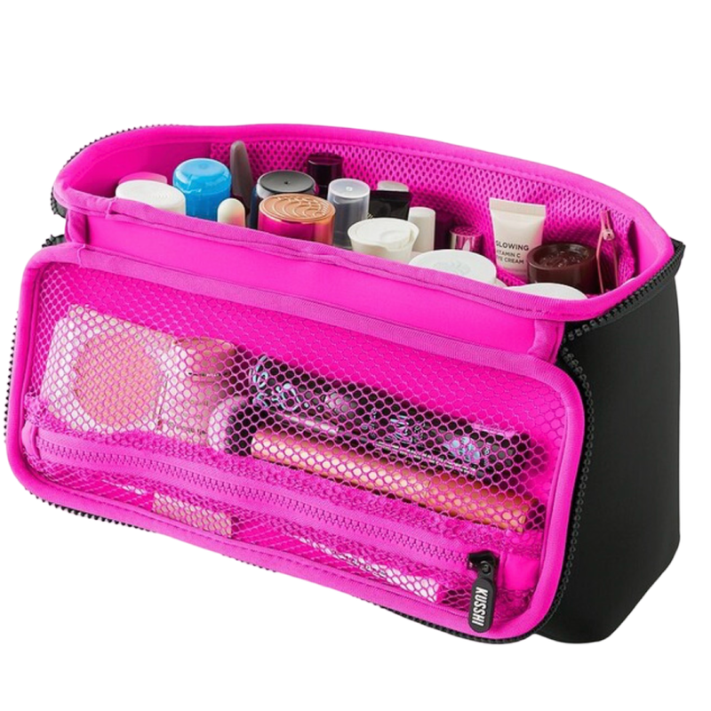 Pink cosmetic bag with various items on a white background