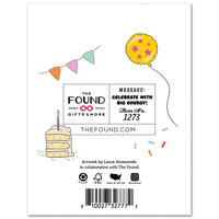 Product packaging with 'The Found' branding, birthday cake illustration, and colorful balloon.