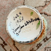 Close-up of a ceramic product with a label on a textured surface