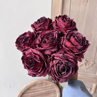 Burgundy vintage-style faux rose bouquet with seven full layered rose stems and leaves