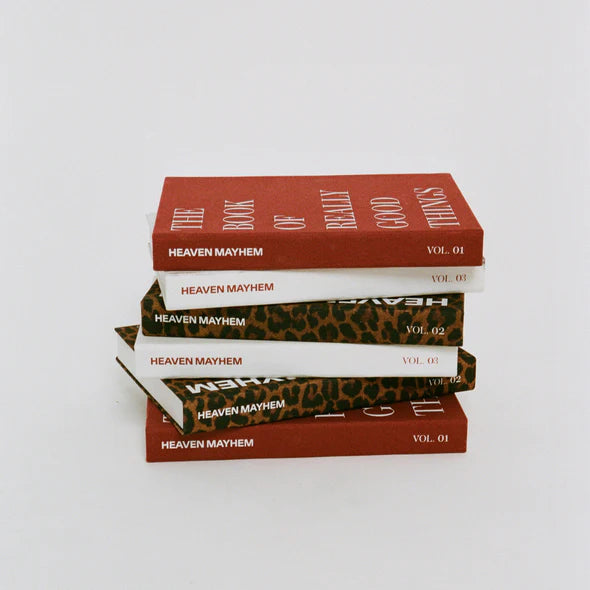 Stack of books titled 'Heaven Mayhem' on a white background