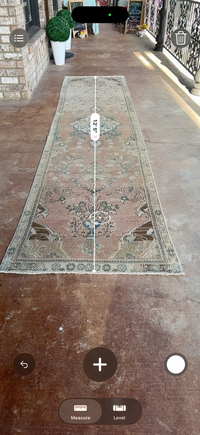 One-of-a-kind vintage Persian runner rug measuring approximately 2'11" x 12'5" with a faded dusty rose ground, blue and turquoise medallion motifs, ivory border and timeworn details.