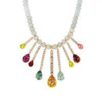Necklace with multicolored gemstones and white beads on a white background