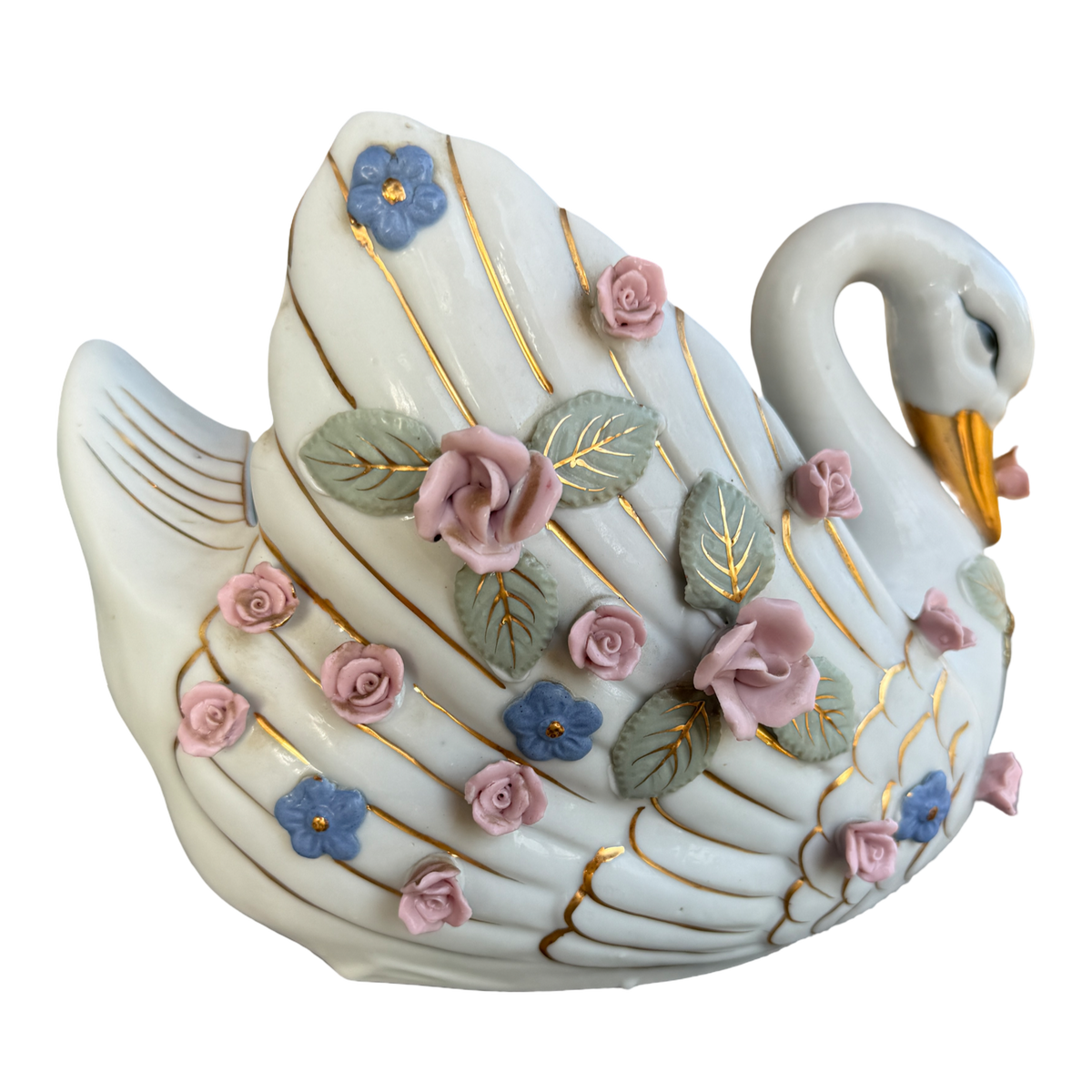 A decorative swan figurine in glossy white porcelain with gold-painted lines, pink roses, blue flowers, and green leaves, isolated on a white background.