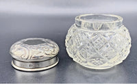 Silver box and clear glass jar on a gray background