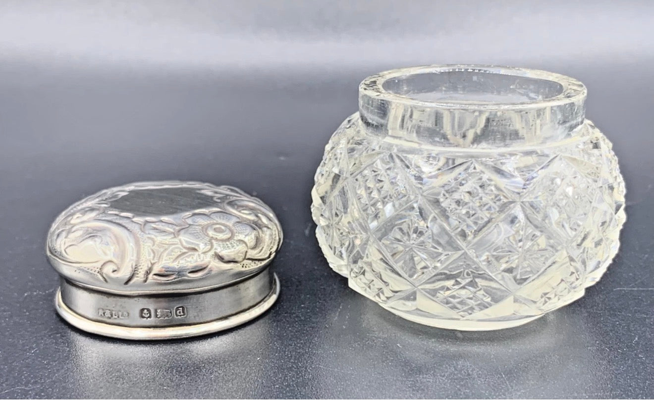 Silver box and clear glass jar on a gray background