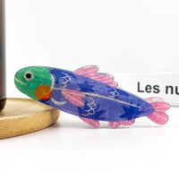 Blue acrylic sardine-shaped hair claw clip with a playful fish silhouette.