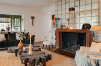 Living room with a fireplace, decorative table, and modern decor.