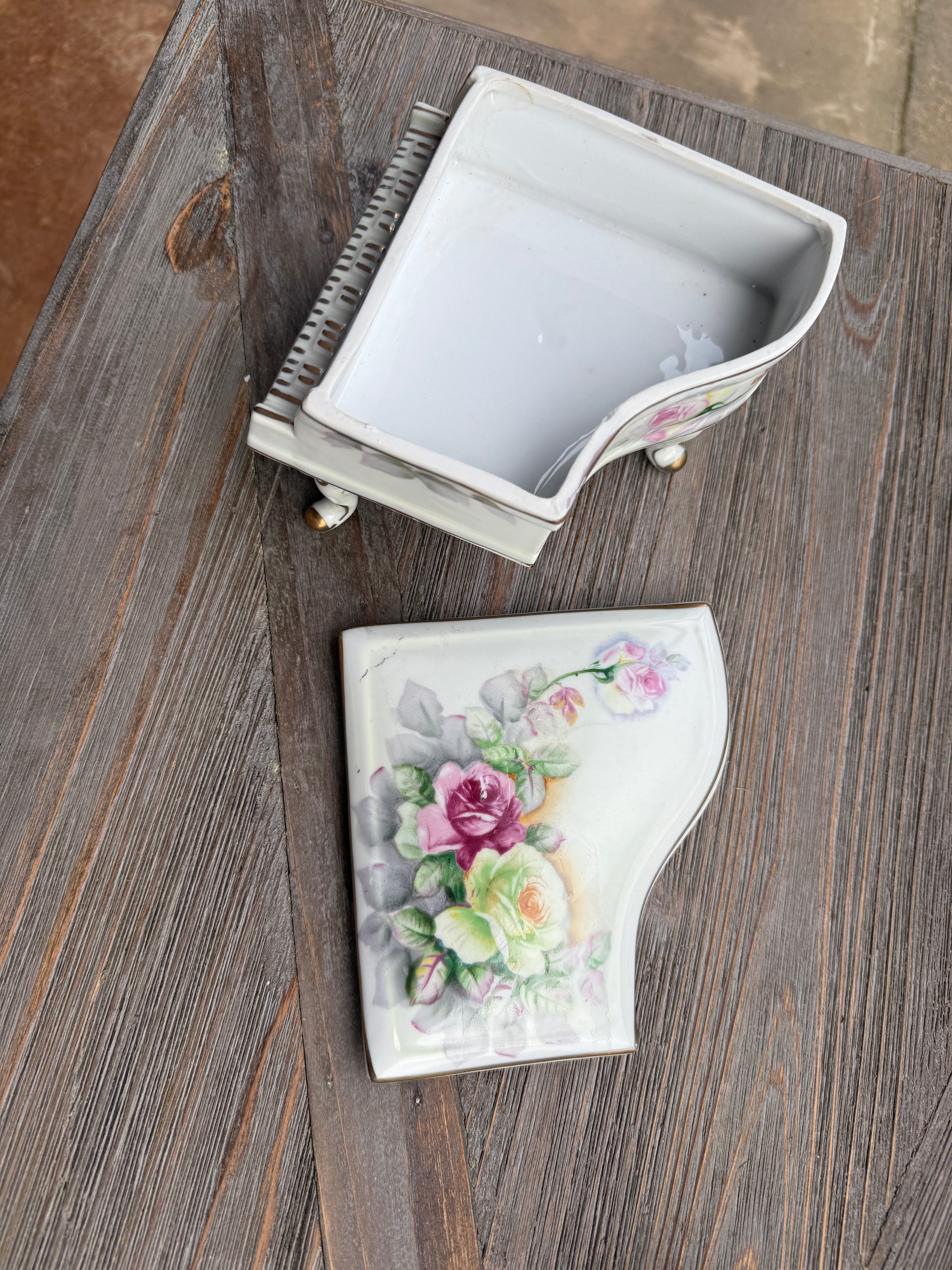 Decorative brush and holder with floral design on a wooden surface