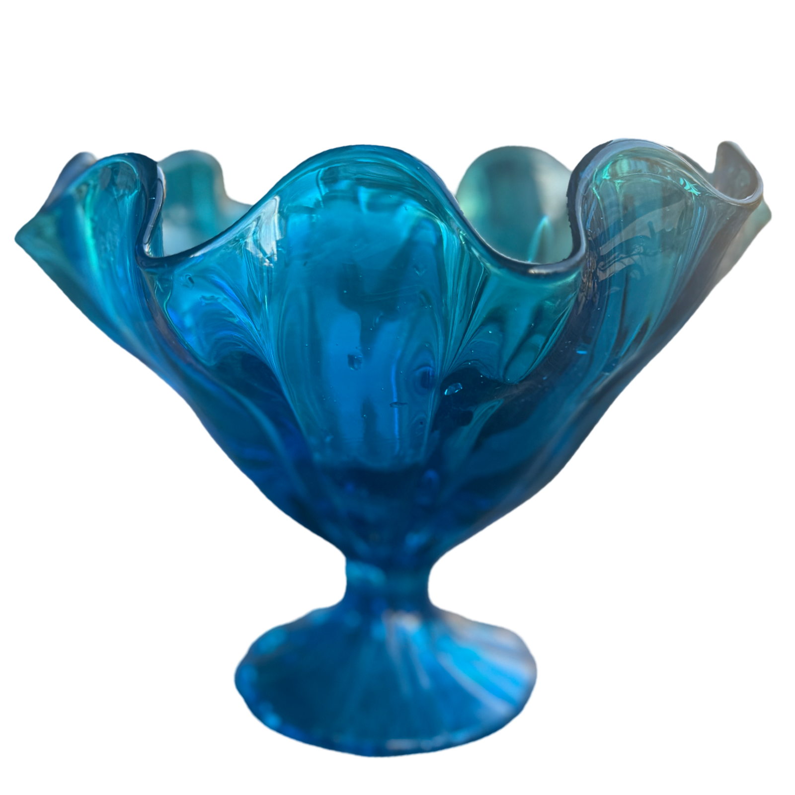 Blue glass bowl with wavy design on a white background