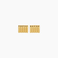 Pair of gold cylindrical earrings on a white background