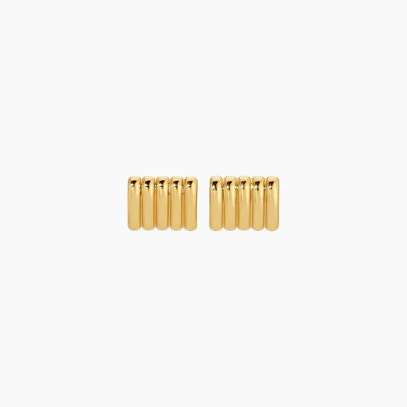 Pair of gold cylindrical earrings on a white background