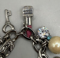 Vintage Juicy Couture silver-tone chunky charm bracelet with strawberry locket, horseshoe, pearl, heart, crystal and turquoise charms