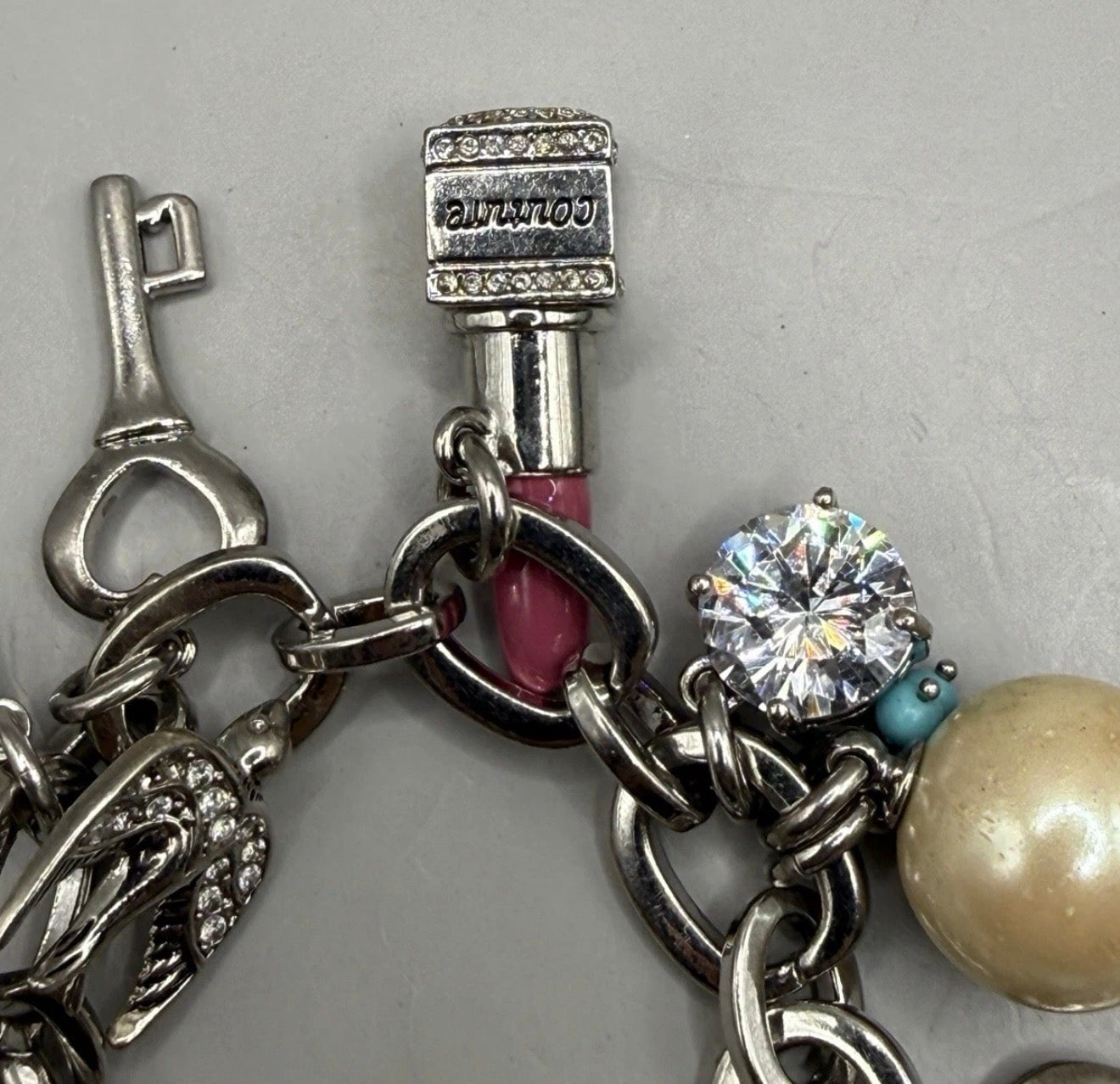 Vintage Juicy Couture silver-tone chunky charm bracelet with strawberry locket, horseshoe, pearl, heart, crystal and turquoise charms