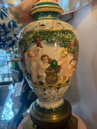 Decorative ceramic vase with angelic design and gold accents