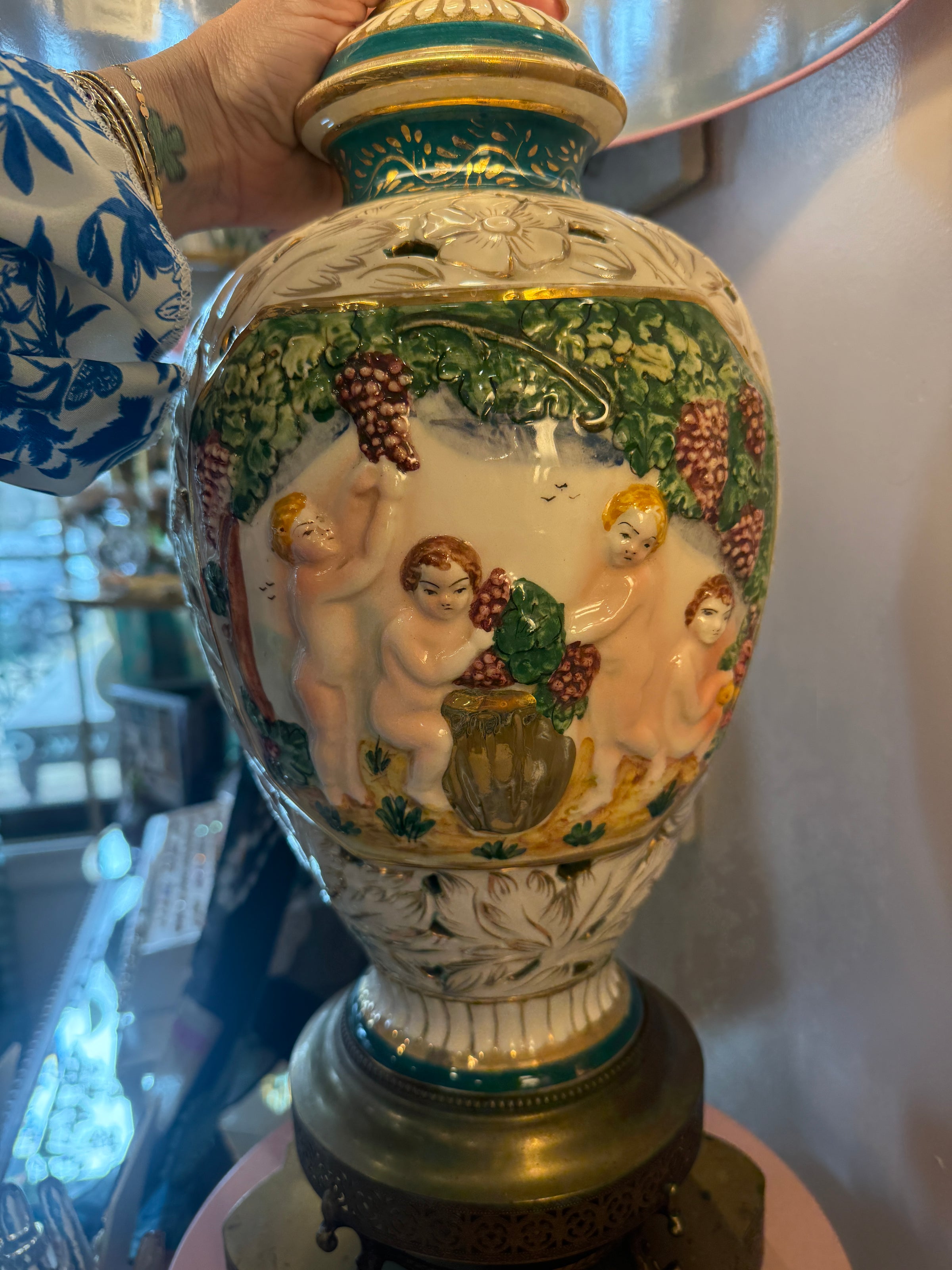 Decorative ceramic vase with angelic design and gold accents