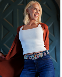 Deep navy wool belt with dimensional lavender, orange, green, cream, and yellow floral embroidery and a lead-free metal buckle.