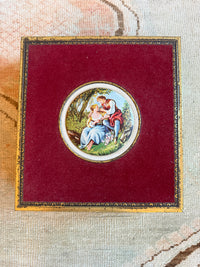 Decorative brooch with a circular design on a red fabric background