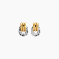 Pair of gold and silver hoop earrings on a white background