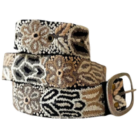 Monochromatic black embroidered wool belt with cream and taupe floral and geometric stitching and a lead-free metal buckle.