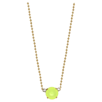 Neon green pendant on a gold chain against a white background