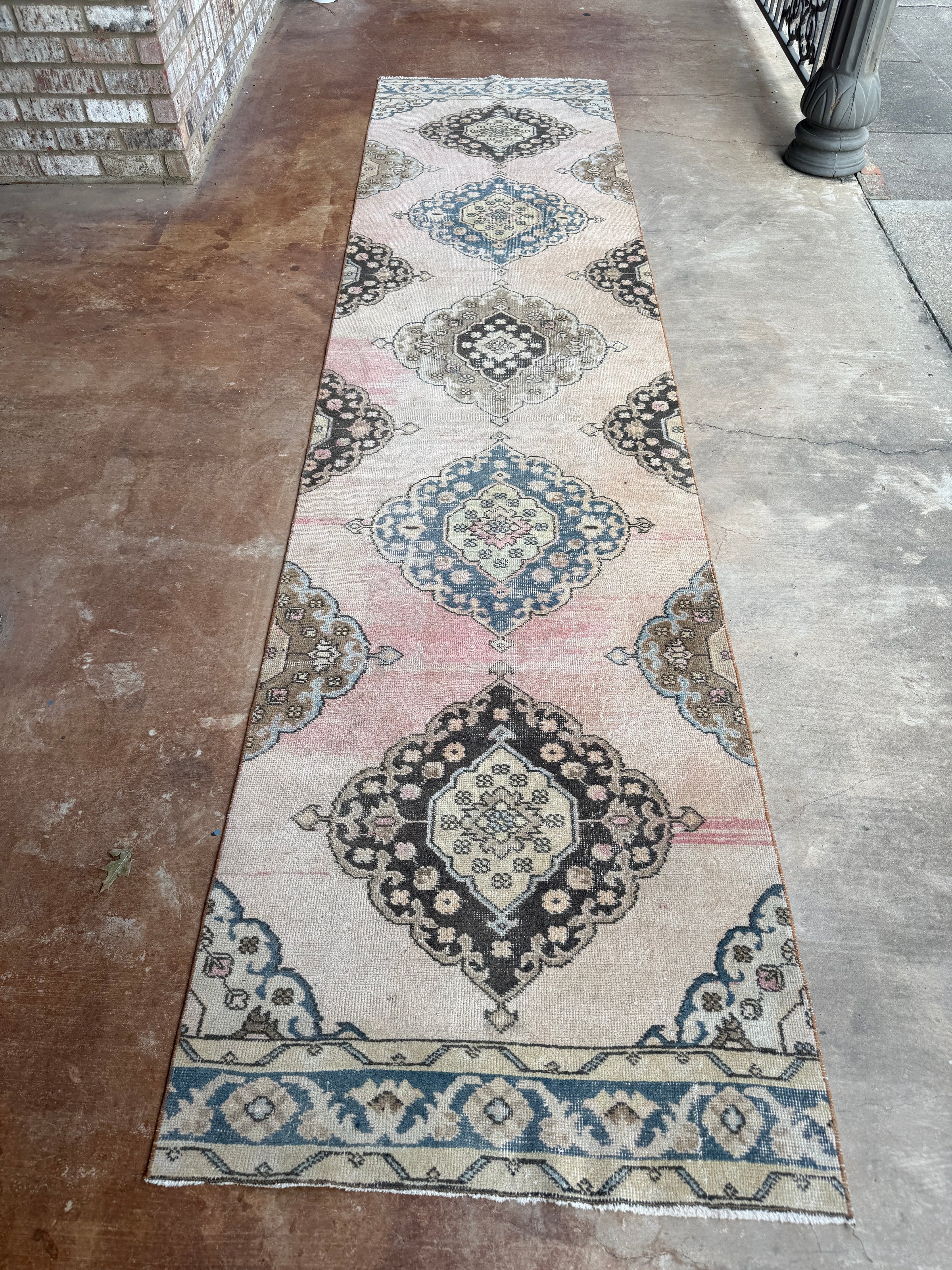 One-of-a-kind vintage wool runner rug with faded blush pink, dusty blue, cream and charcoal medallion pattern, approximately 2'11" x 12'3".