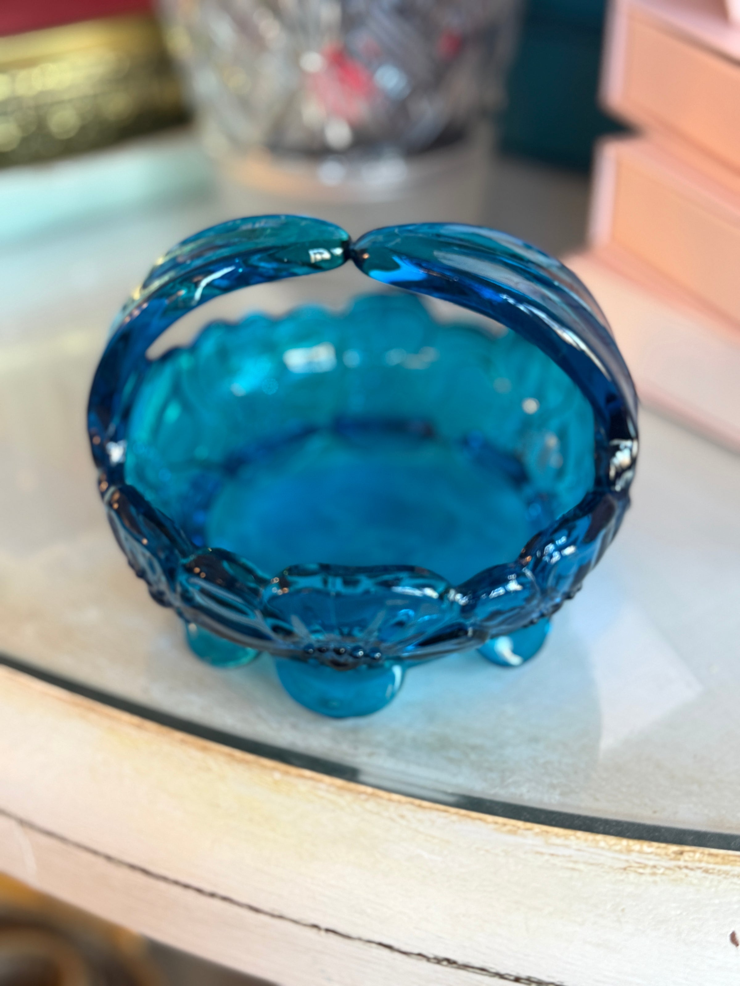 Blue glass ashtray on a reflective surface