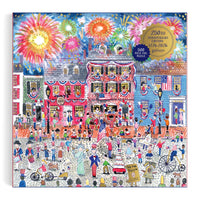 Jigsaw puzzle box with a colorful illustration of a town square with people and fireworks, featuring the Galison brand.