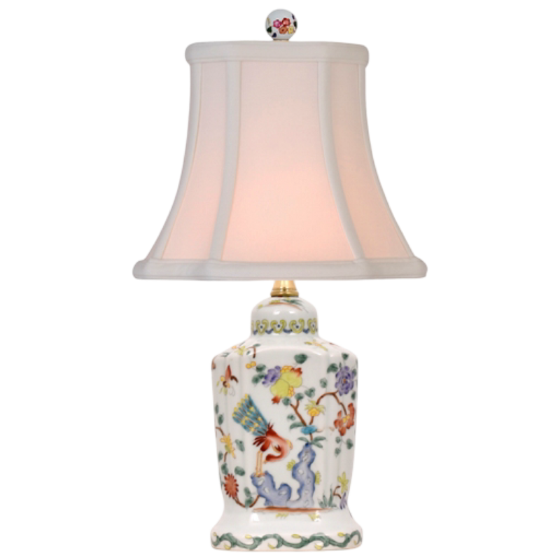 Decorative table lamp with floral design on a white background