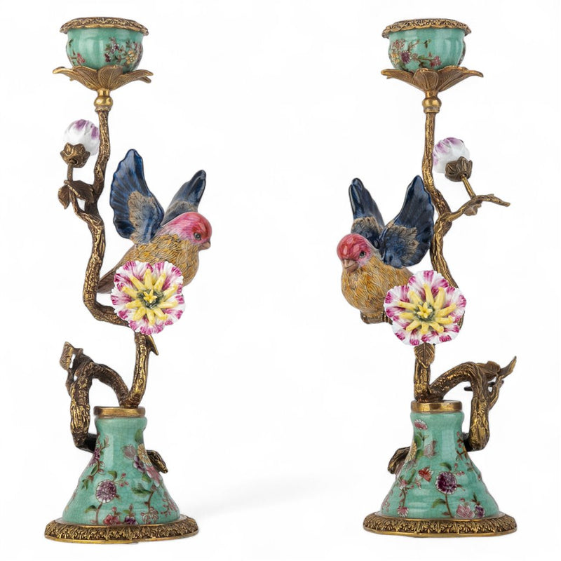 Decorative candle holders with birds and floral designs on a white background