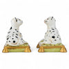 Two ceramic dog figurines with black spots on a white background