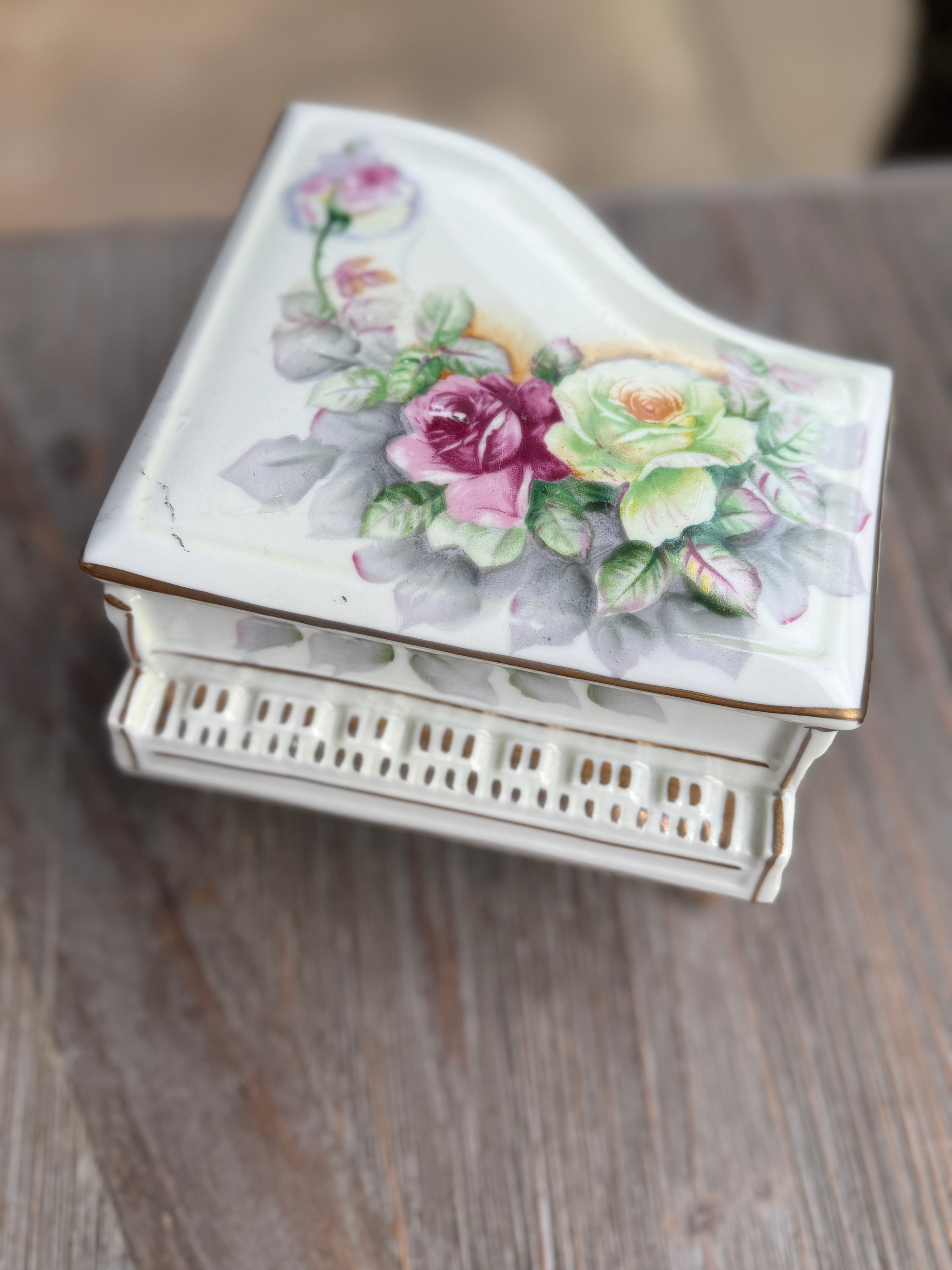 Decorative jewelry box with floral design on a wooden surface