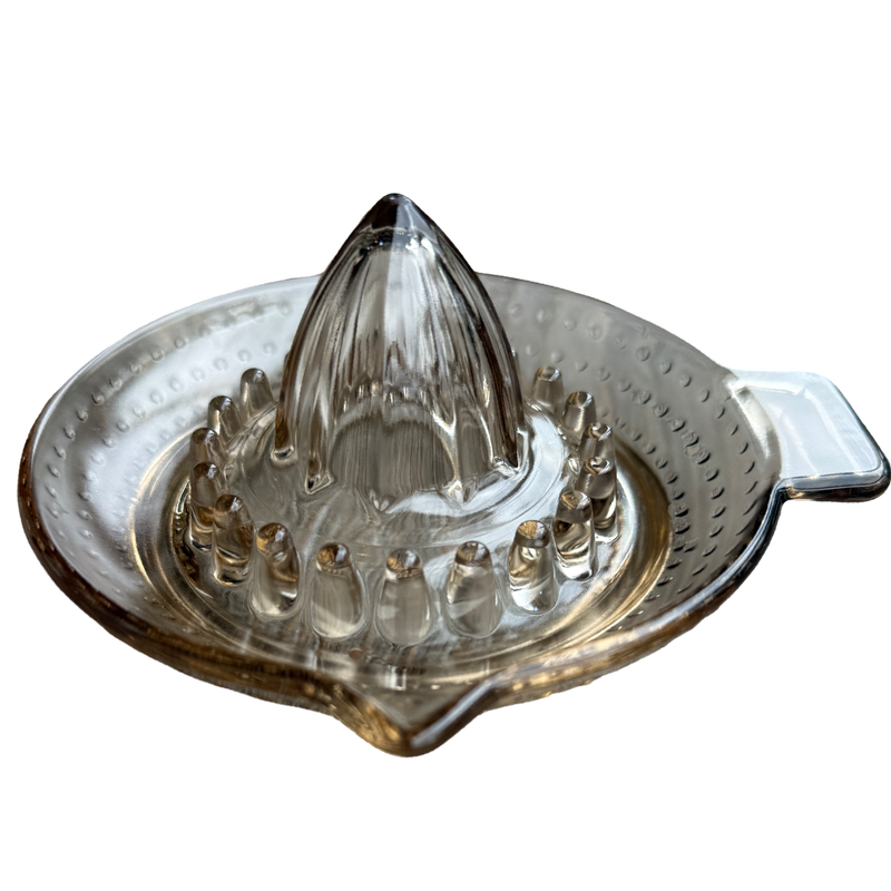 Clear glass citrus juicer on a white background