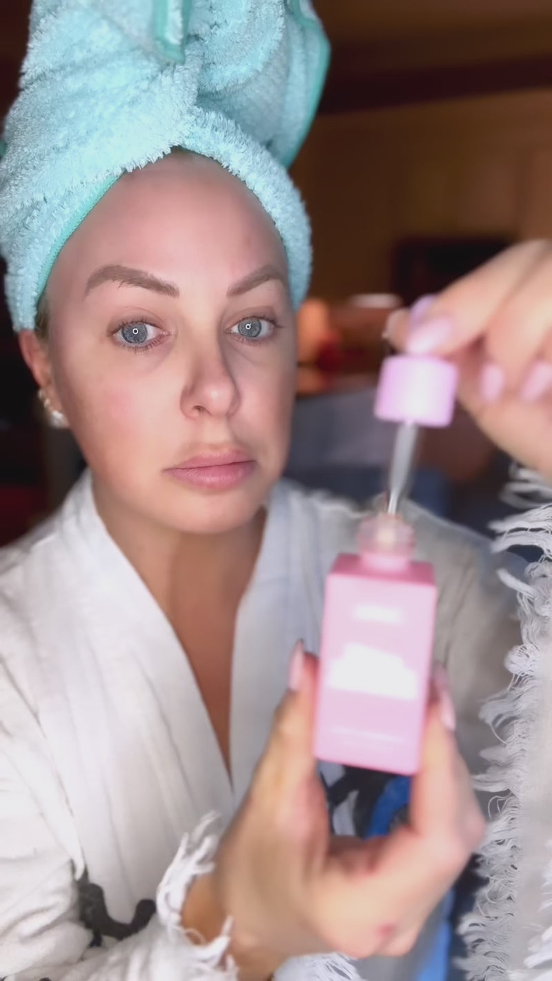 demonstrating the skinny confidential ice queen face oil and the pink ice roller for perfect morning routine