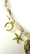 Mandriana, scarf necklace, heart charm necklace, handmade charm jewelry, beachy boho accessory, cross charm necklace, starfish necklace, symbolic jewelry, neutral bandana necklace, one of a kind statement piece, artisanal jewelry, boho chic accessories, charm scarf necklace, textured heart necklace