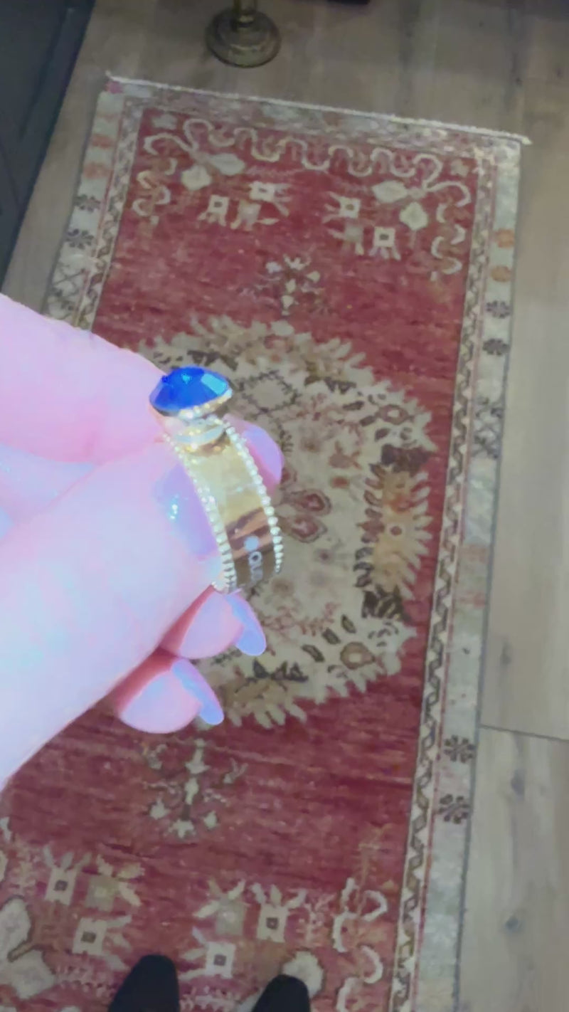 showcasing how the qudo punto gold interchangeable ring base works by screwing on and off the swarovski crystal jewel.