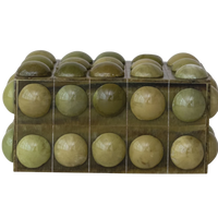 Green spherical objects in a clear plastic packaging on a white background