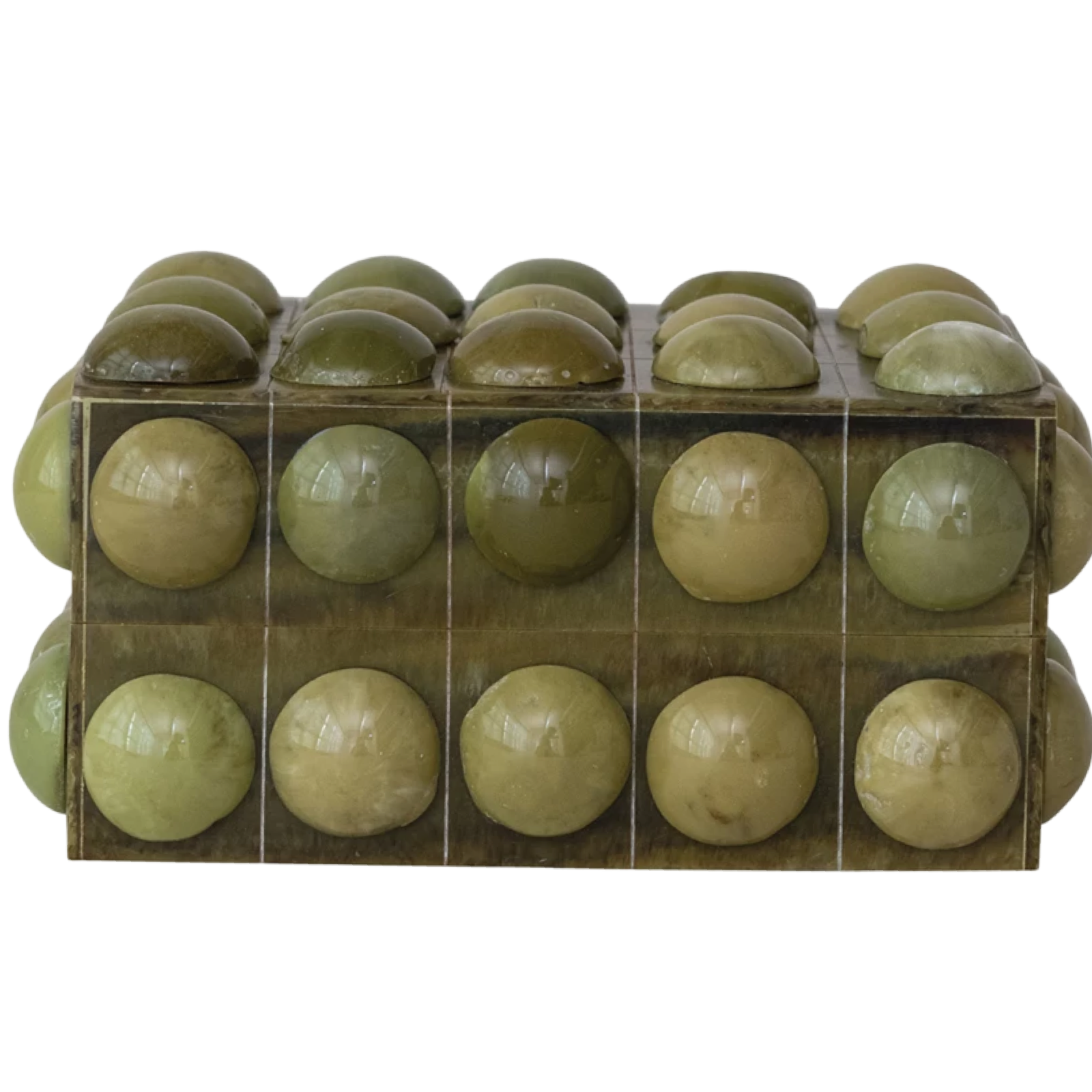 Green spherical objects in a clear plastic packaging on a white background