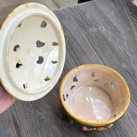 Two ceramic incense holders on a wooden surface